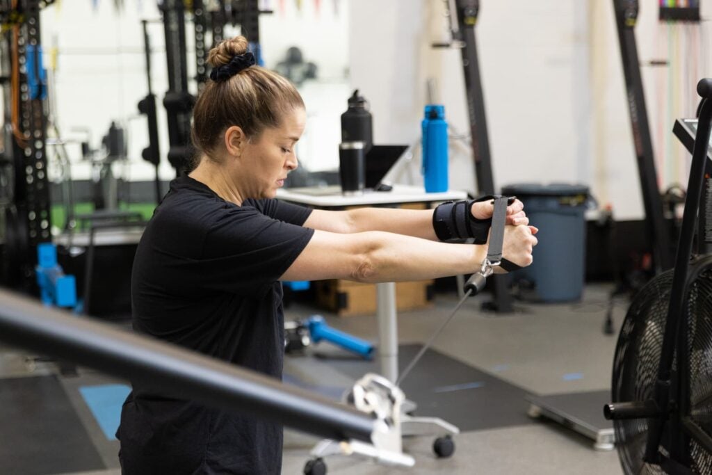 Woman doing cable workout in gym