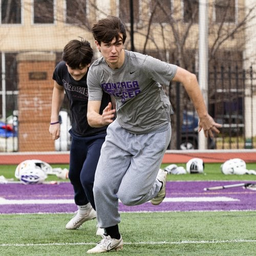 Two athletes running during soccer practice