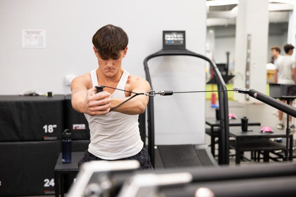 Man exercising with cable machine at gym