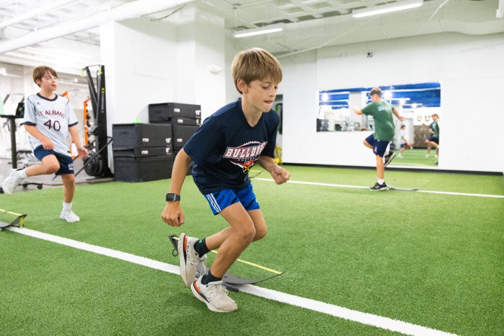 Kids exercising on indoor turf field.