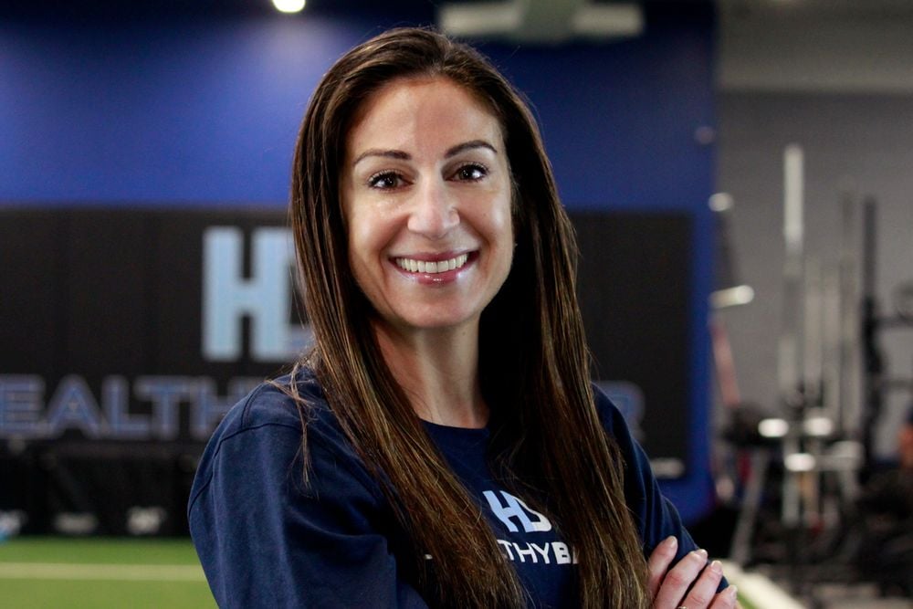 Smiling woman in gym setting.