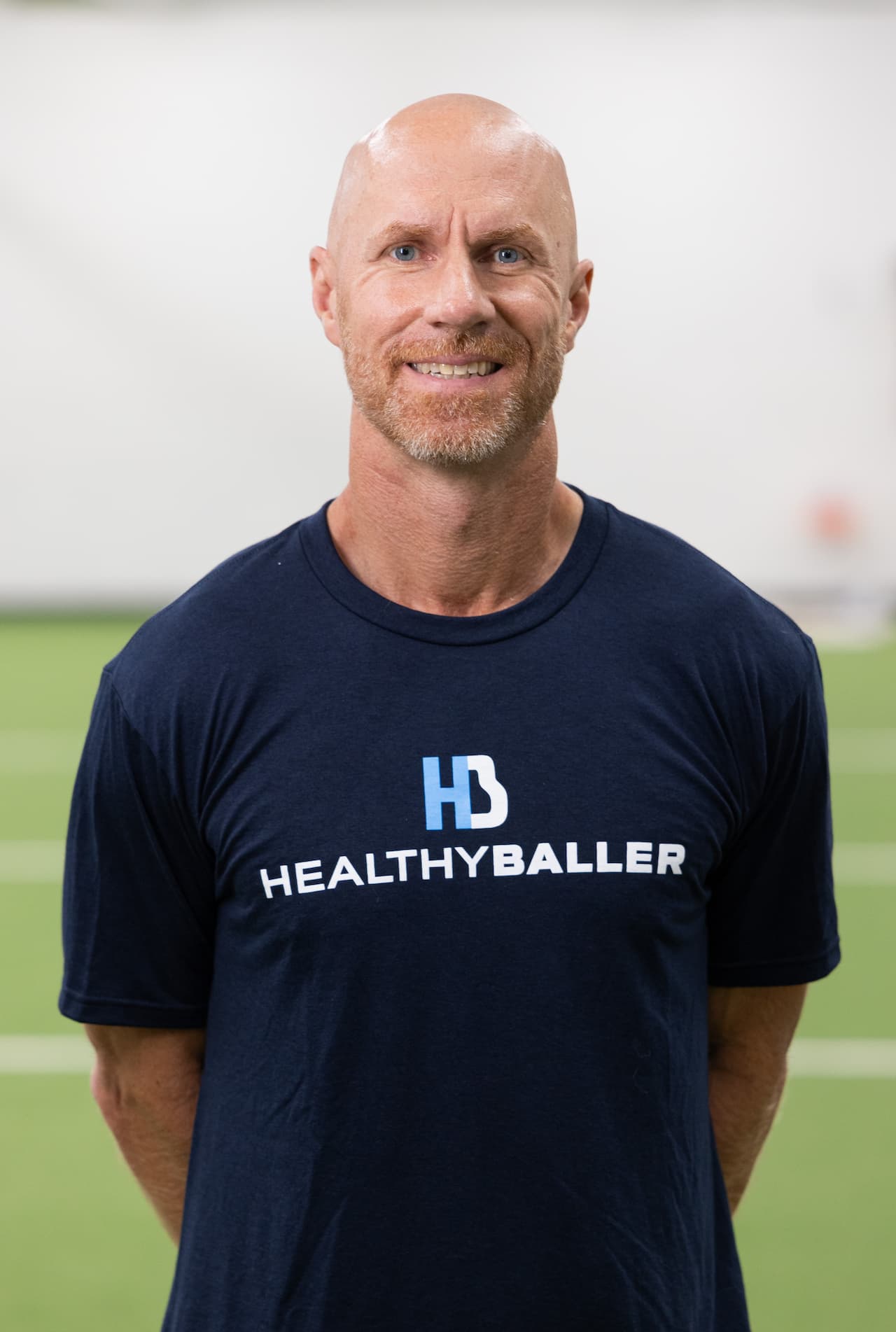 Man in Healthy Baller shirt smiling in gym