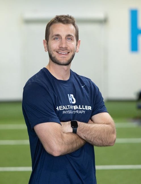 Smiling man in gym with fitness logo shirt