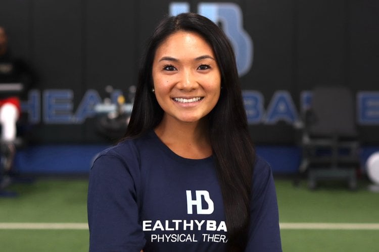 Smiling physical therapist in gym setting