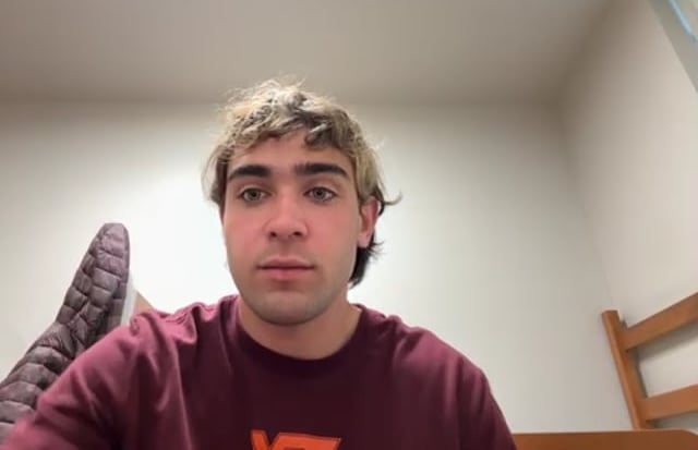 Person sitting in room with bunk bed