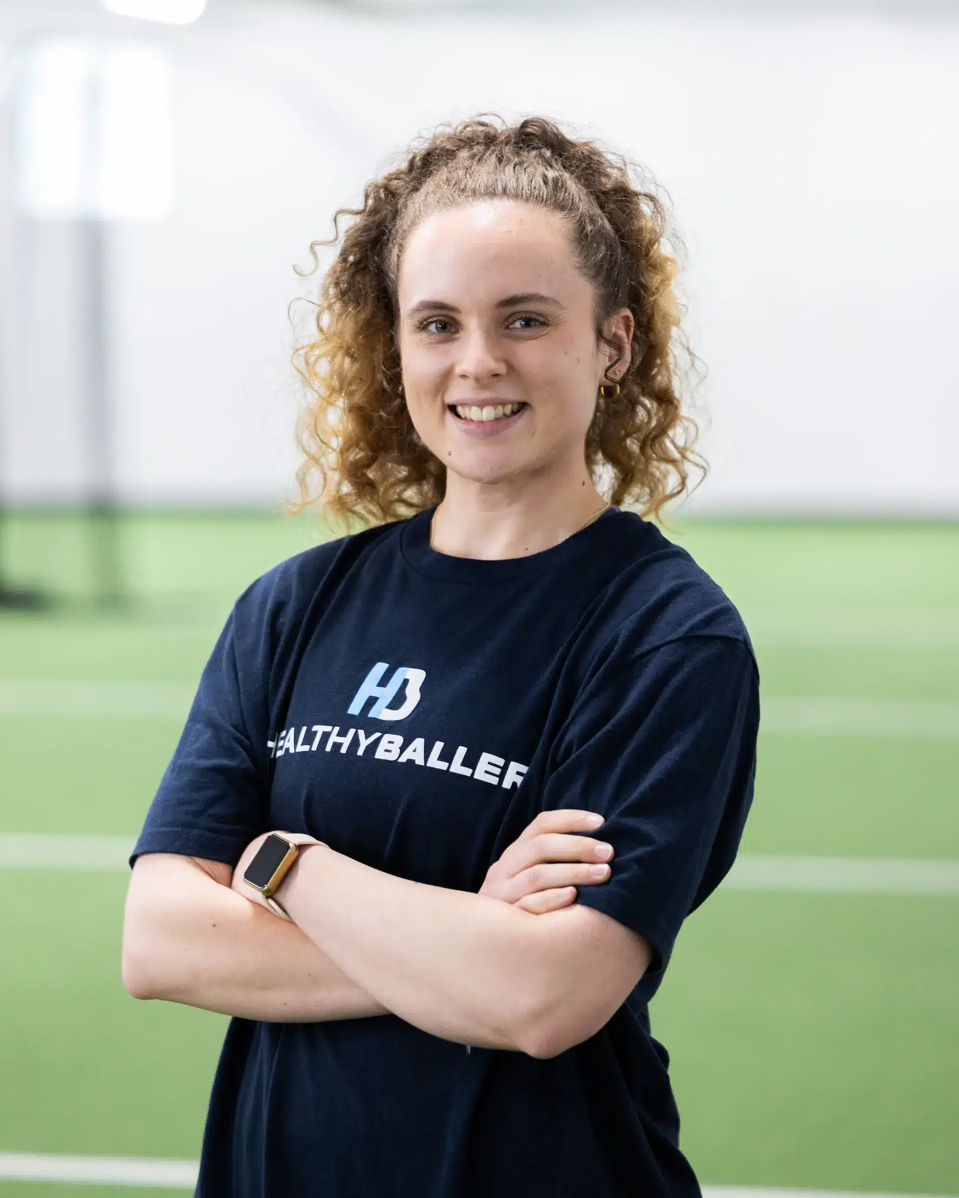 Smiling person in sports shirt on field