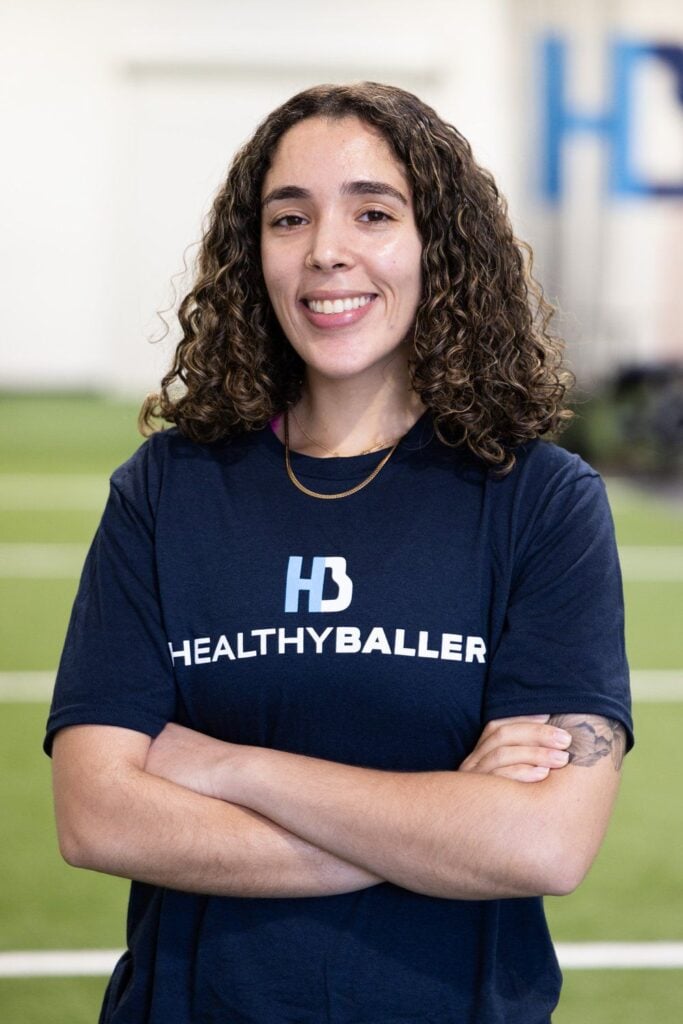 Smiling person wearing Healthy Baller shirt.