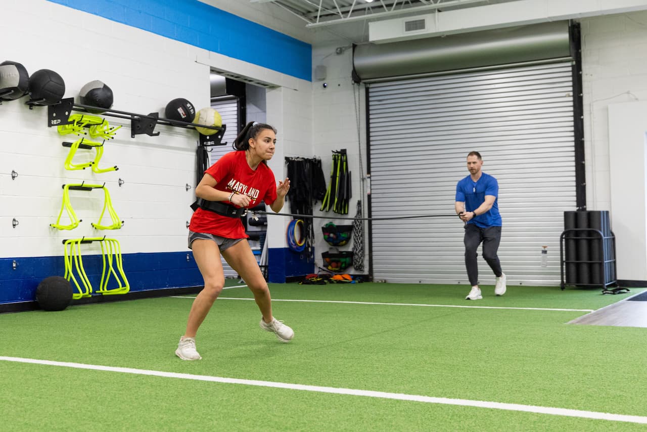 Athletic training exercise with resistance band indoors.