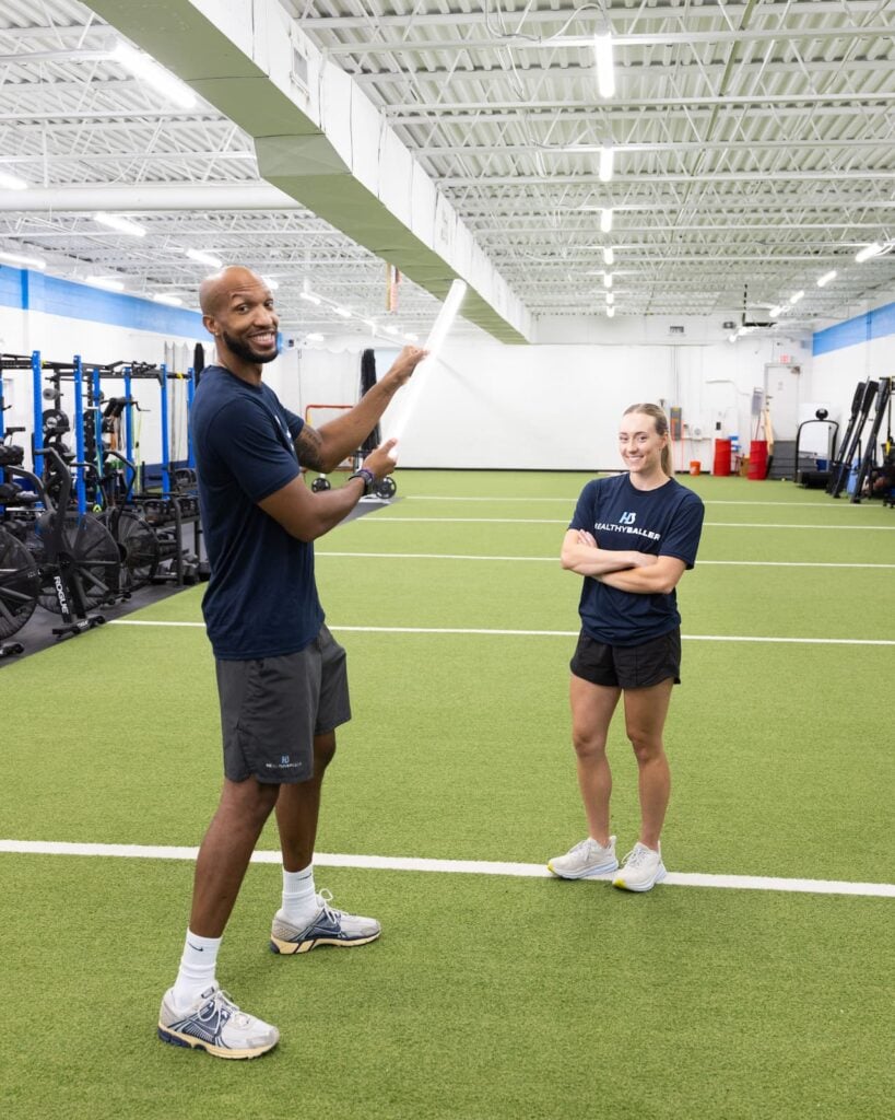 Two trainers in a sports facility.