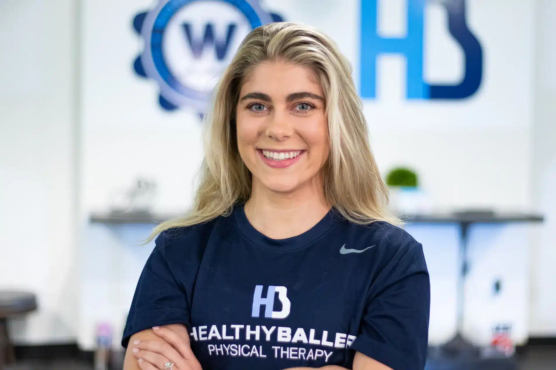 Person in 'Healthy Baller' therapy shirt smiling.