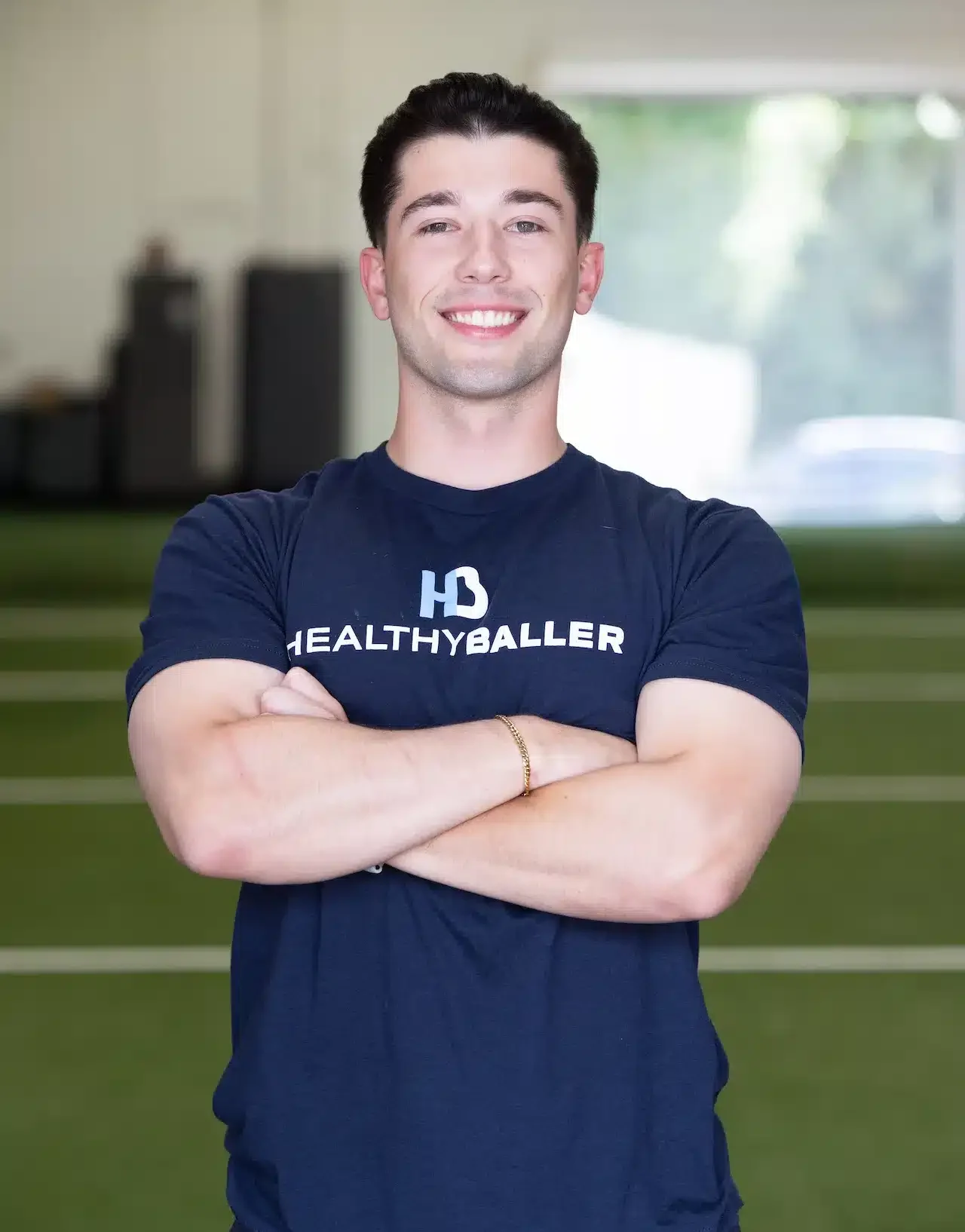 Man in gym wearing HealthyBaller shirt.