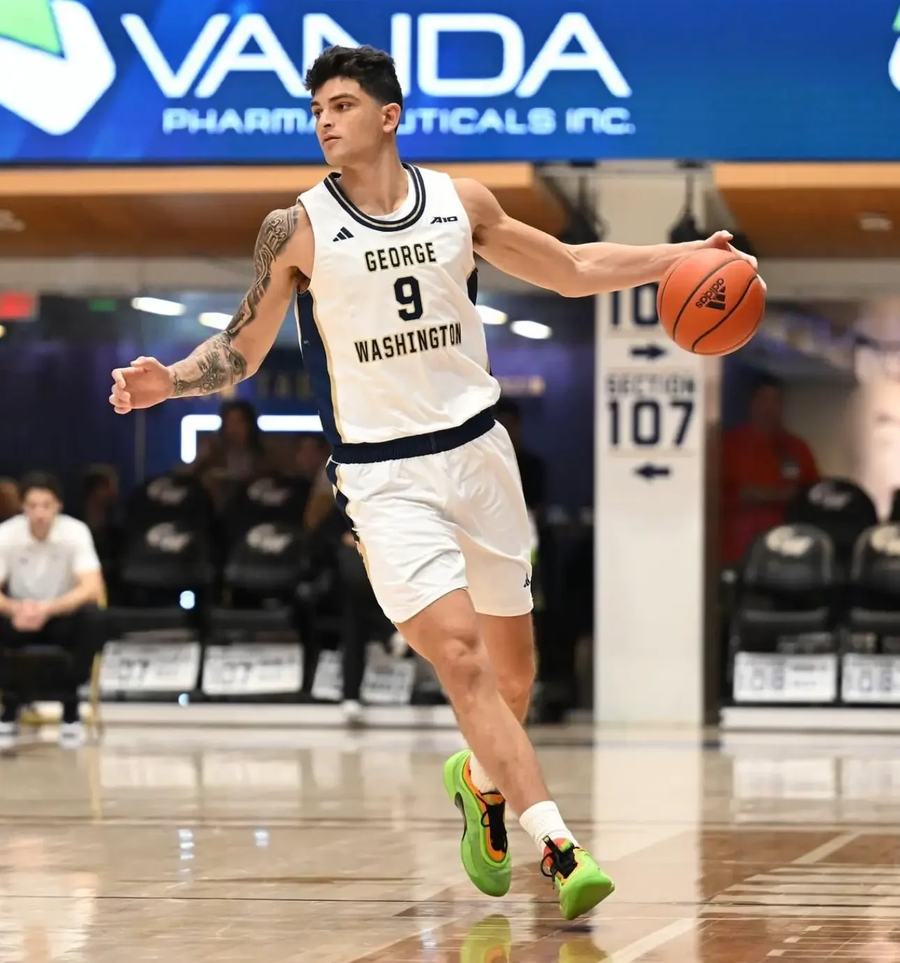 Basketball player dribbling on court during game.