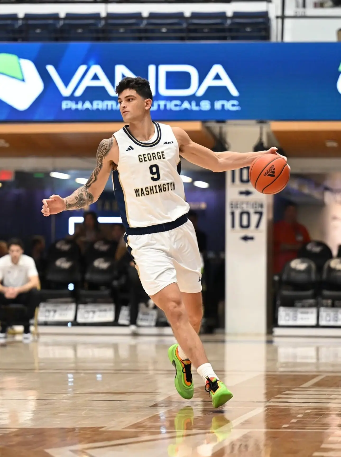 Basketball player dribbling on court during game.
