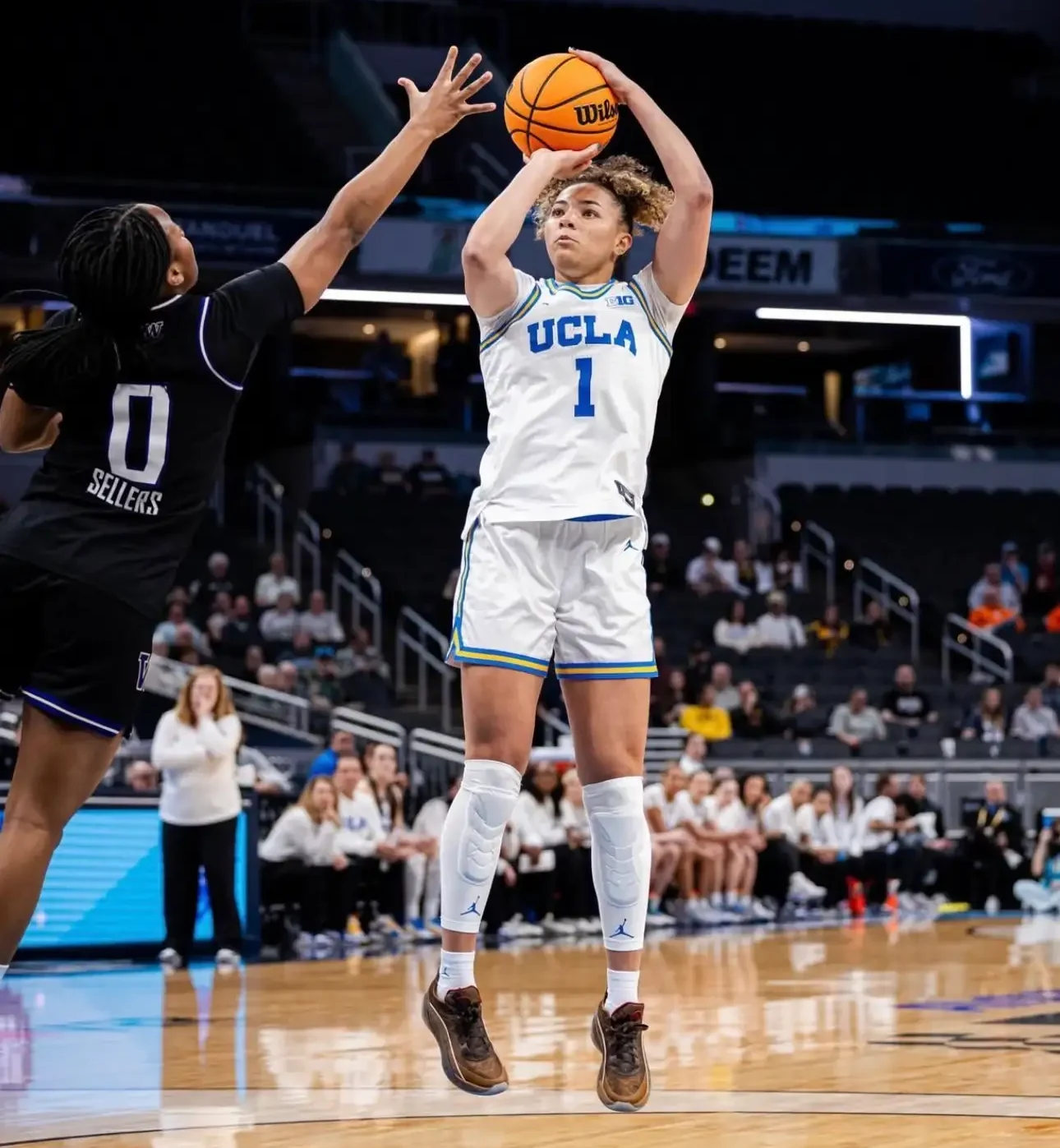 UCLA player jumping for basketball shot on court.