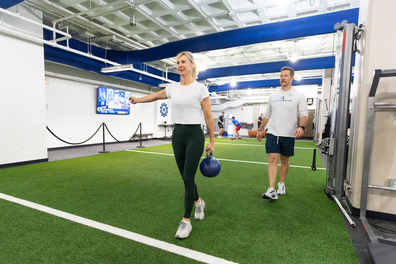 Woman exercising with a kettlebell indoors