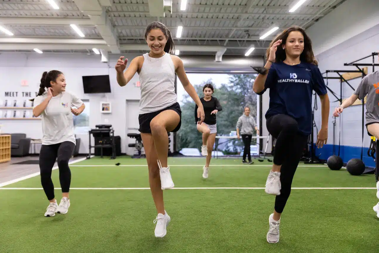 Group of women doing high knees in gym
