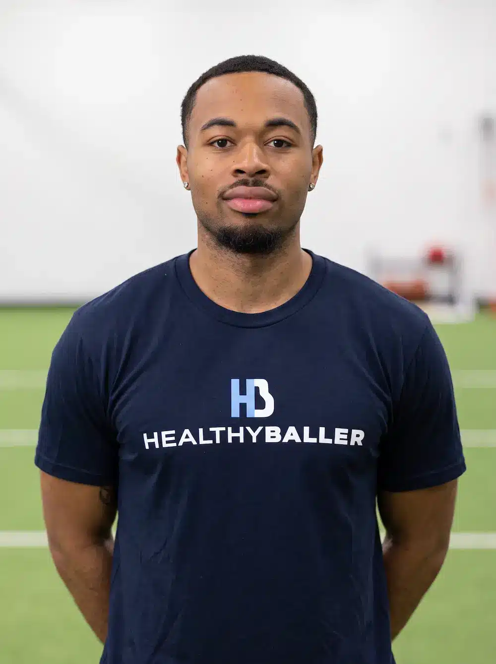 Man wearing HealthyBaller shirt in indoor training facility